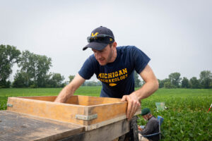 University of Michigan archeologist Brendan Nash screens excavated soil for manufacturing debris and Clovis tools on the Belson Clovis Site in St. Joseph County. Image credit: Daryl Marshke/Michigan Photography