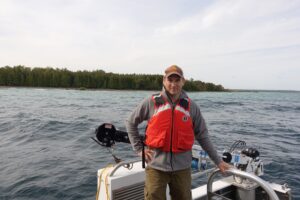 U-M microbiologist and oceanographer Gregory Dick aboard R/V Storm near Lake Huron's Middle Island Sinkhole. The Storm is a 50-foot NOAA research vessel. Photo credit: Jim Erickson, University of Michigan News.