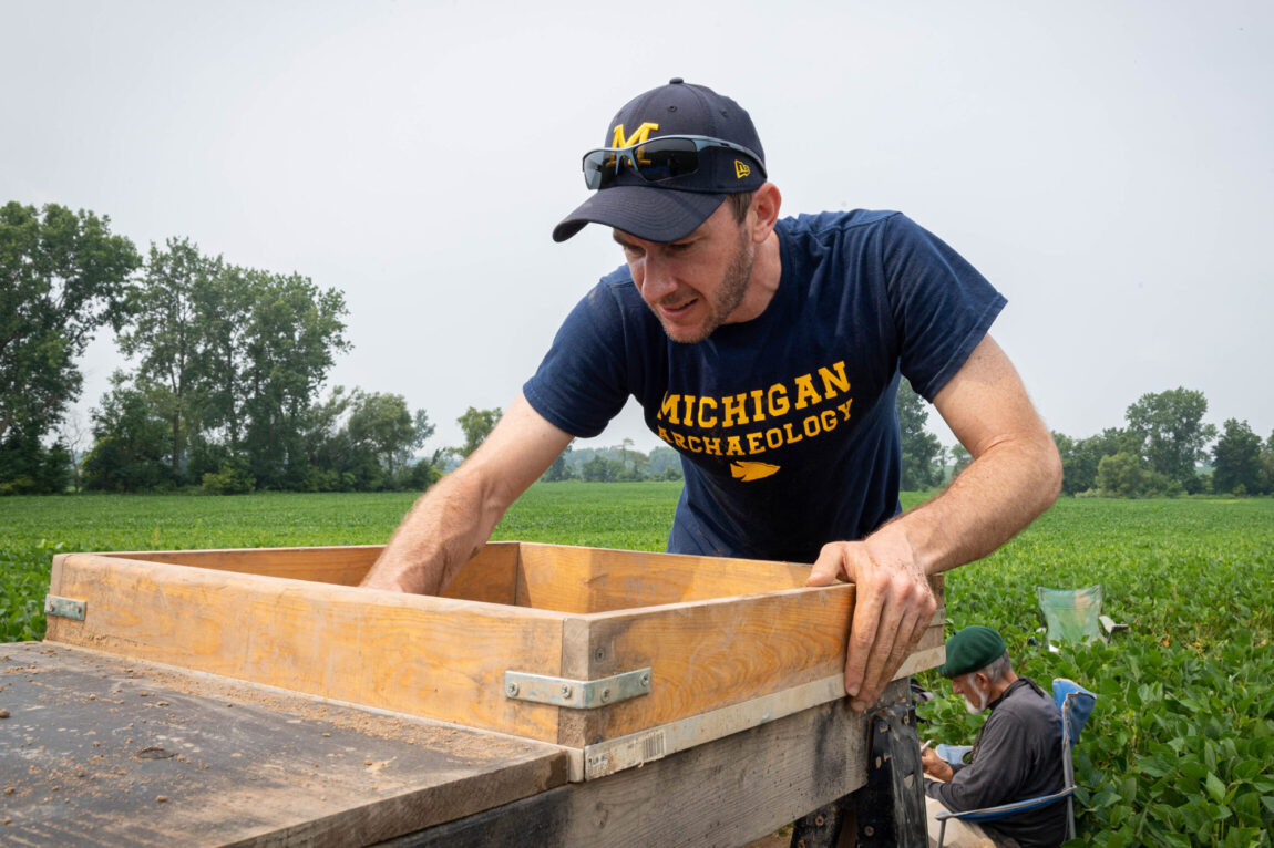 Photo of Brendan Nash screening excavated soil