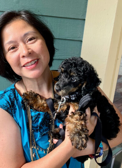 Christi-Anne Castro, associate professor of music and associate dean for faculty development in the School of Music, Theatre & Dance, holds Banjo, a poodle she and her family recently adopted. (Photo courtesy of Christi-Anne Castro)