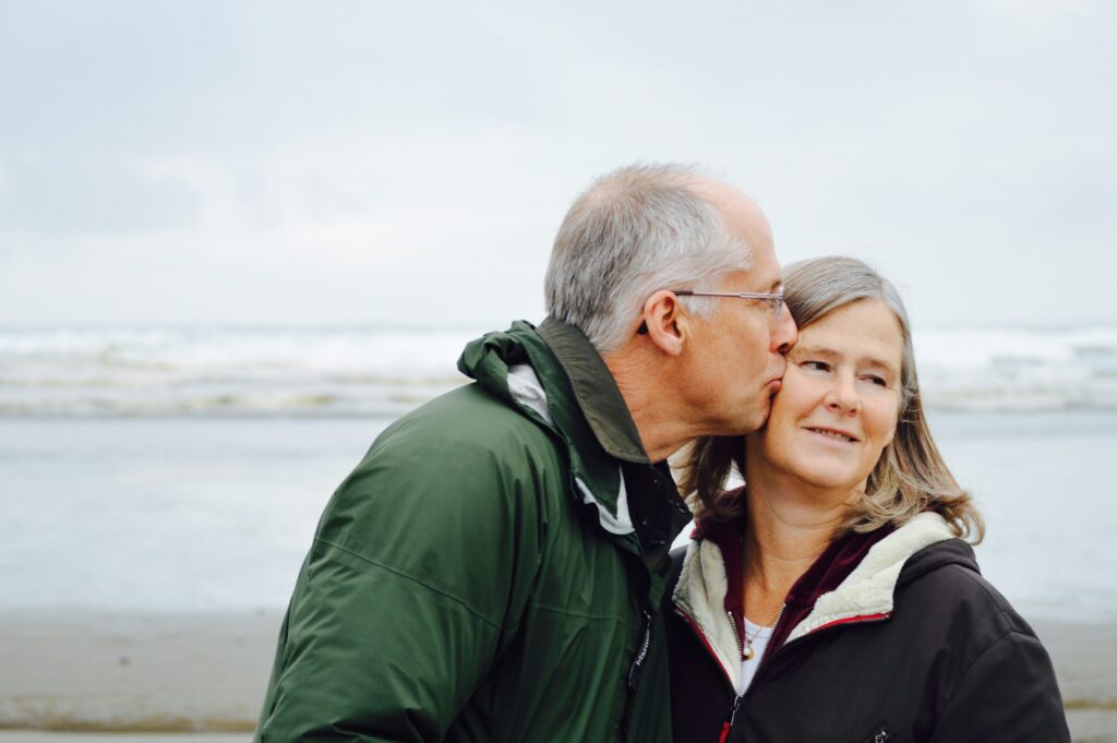 An older smiling couple. Image credit: Esther Ann, Unsplash