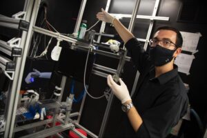 Samuel Nason, a PhD student in biomedical engineering at the University of Michigan, is a member of a research team that has captured brain signals capable of controlling individual finger movements in primates. Image credit: Marcin Szczepanski/University of Michigan Engineering