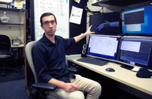 Samuel Nason, a PhD student in biomedical engineering at the University of Michigan, is a member of a research team that has captured brain signals capable of controlling individual finger movements in primates. Image credit: Marcin Szczepanski/University of Michigan Engineering
