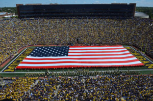 One of many patriotic tributes the Michigan Marching Band has performed over the years, their halftime show on Sept. 7, 2019 during the game against Army Black Knights unveiled a massive American Flag and a full lineup of patriotic music. Image credit: Robert Brown