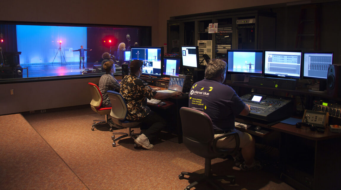 A motion capture demonstration is filmed in the Duderstadt Center Video Studio while staff monitor and record sound and video content from the video studio control room. (Photo courtesy of Duderstadt Center staff)