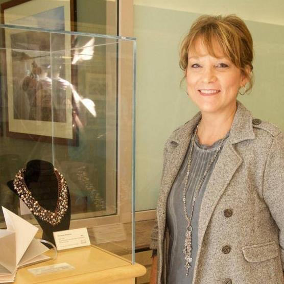 Kathy Sodt, a senior business intelligence analyst with Enterprise Data and Information Services and Health Information Technology & Services at Michigan Medicine, stands next to a piece of jewelry she made. (Photo courtesy of Kathy Sodt)