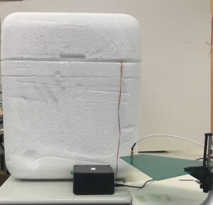 Testing a temperature probe inside a cooler of dry ice. Image credit: Yan Long