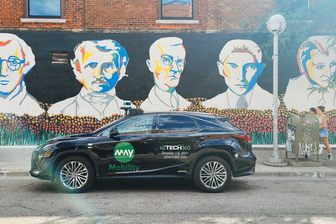 A photo of an A2GO vehicle in front of an iconic downtown mural along Liberty Street.