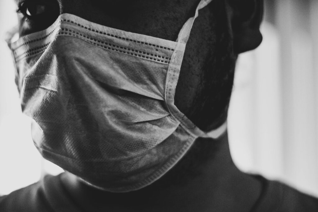 A Black man wearing a mask. Image credit: Tai's Captures, Unsplash.com