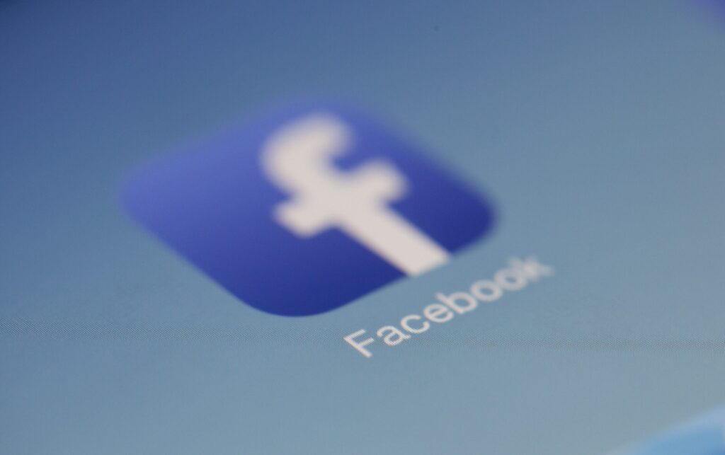 Blurred Facebook logo.