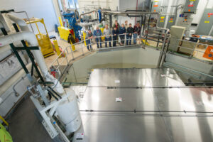 The installation team overlooks the finished MicroBooNE cosmic ray tagger system. Image credit: Reidar Hahn
