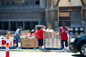 Volunteers at the Historic King Solomon Baptist Church distribute food to people during a food drive. Image credit: Eric Bronson, Michigan Photography