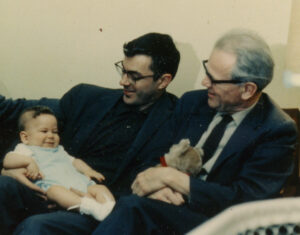 Karl Zinn holds baby Fred while Frank Copley looks on.