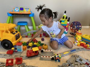 A photo of the researcher's daughter playing with plastic toys. Image courtesy the researchers