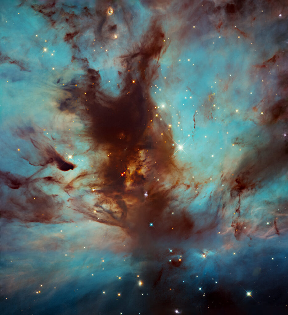 The Flame Nebula is a large star-forming region in the constellation Orion that lies about 1,400 light-years from Earth. It’s a portion of the Orion Molecular Cloud Complex, which includes such famous nebulae as the Horsehead Nebula and Orion Nebula. This image focuses on the dark, dusty heart of the nebula where a star cluster resides, mostly hidden from view. Image credit: NASA, ESA, and N. Da Rio (University of Virginia); Processing: Gladys Kober (NASA/Catholic University of America)