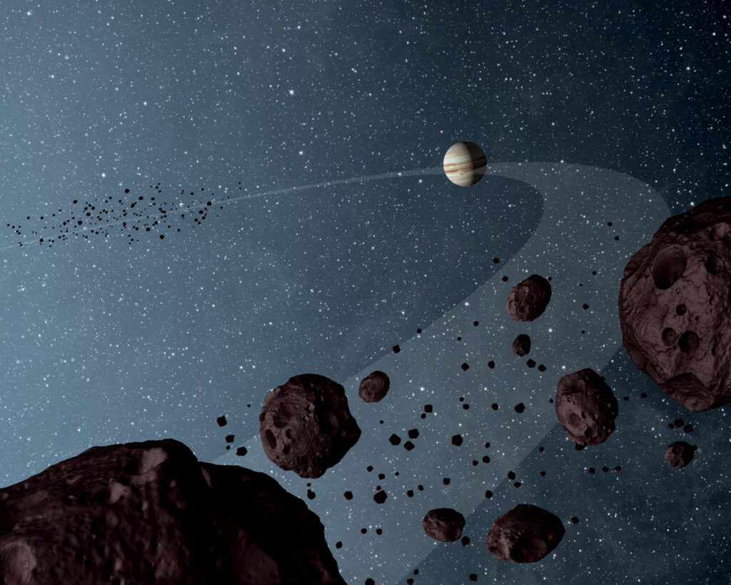 This artist's impression shows Jovian Trojans, based on data from a 2012 study by NASA's Wide-field Infrared Explorer, or WISE. The Jovian Trojans—asteroids that lap the sun in the same orbit as Jupiter—are uniformly dark with a hint of burgundy color, and have matte surfaces that reflect little sunlight. Image credit: NASA/JPL-Caltech