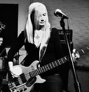 Anne Kadrovich plays the bass guitar, one of many instruments she has played over the course of a long musical career. (Photo courtesy of Anne Kadrovich)