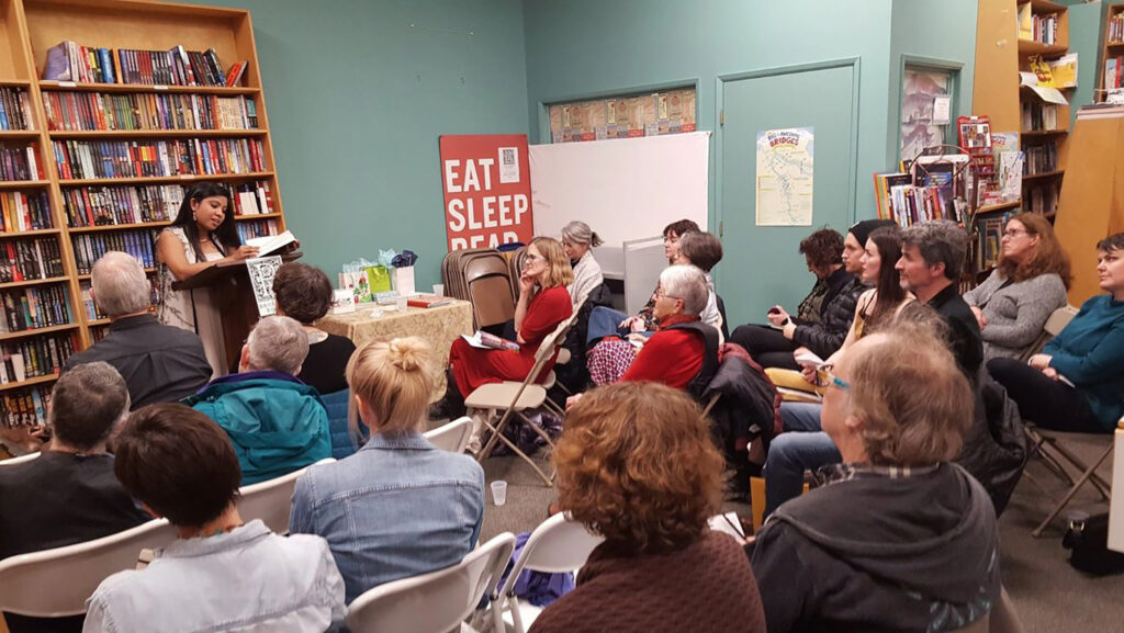 Debotri Dhar, lecturer II in women’s and gender studies in LSA, reads at a gathering of the Hummingbird Global Writers’ Circle at Broadway Books in Portland, Oregon, in March 2018. (Photo courtesy of Debotri Dhar)