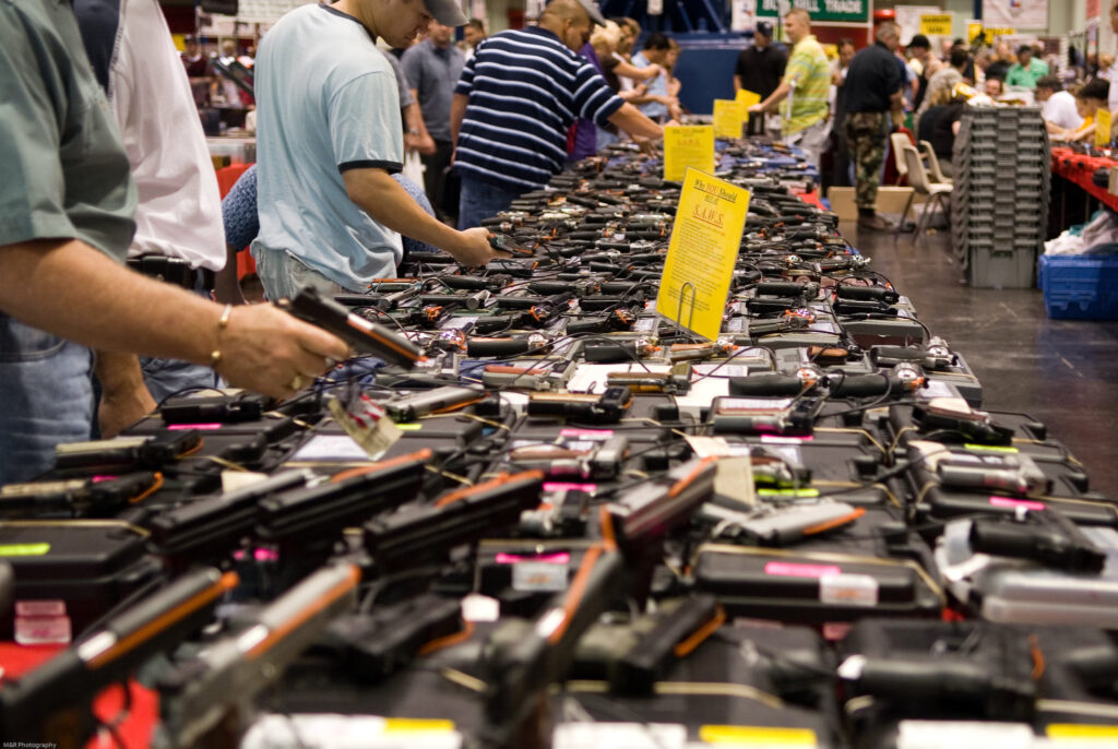 Table of guns at a Houston Gunshow. Image credit: M&R Glasgow, CC BY 2.0 (https://creativecommons.org/licenses/by/2.0/)