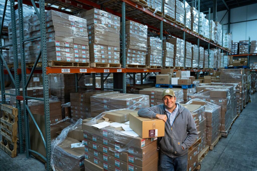 Brandon Seng, founder and owner of the Traverse City-based Michigan Frozen Foods, and Michigan Farm to Freezer in the company’s Detroit warehouse. Image credit: Eric Bronson, Michigan Photography