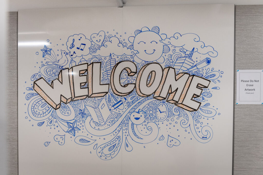 Photo of "Welcome" on a whiteboard.