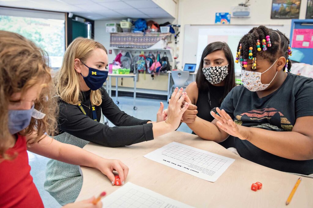 Students in the Master of Arts with Elementary Teacher Certification program work with elementary school students at Ann Arbor Open School in July 2021. Image credit: Leisa Thompson