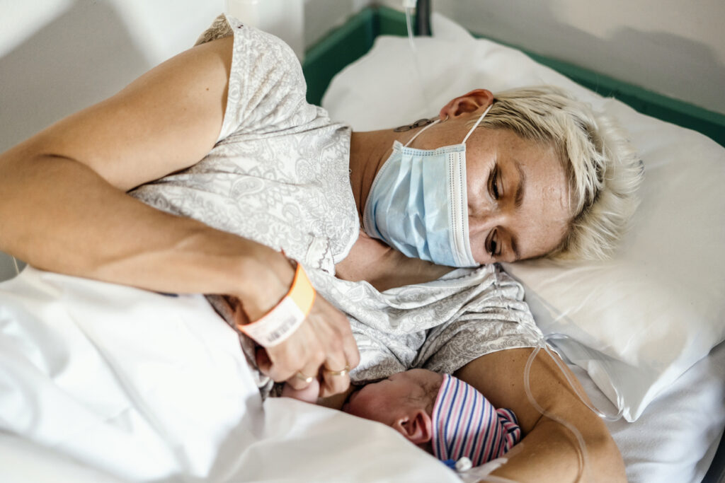 A new mother nursing her newborn baby during the COVID-19 pandemic. Image credit: iStock