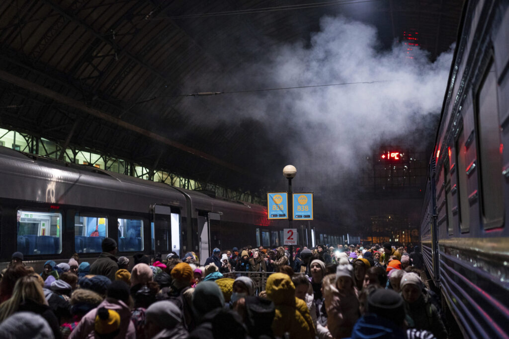 People are seen crowding the city main train station at night in Lviv, Ukraine. Image credit: Davide Bonaldo/Sipa USA,(Sipa via AP Images)