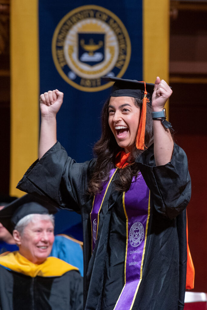 Photo of Rackham graduate cheering