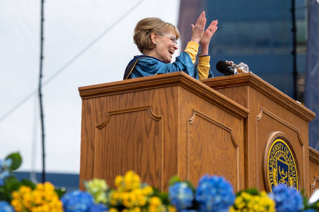 Photo of President Mary Sue Coleman cheering the graduates