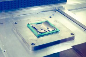 A steel plate in the shape of a Block M is marked with a laser inside the LPBF Panda 11 printer. Image credit: Evan Dougherty/Michigan Engineering