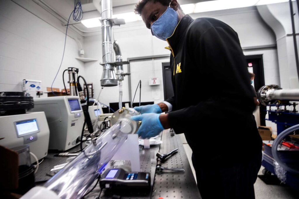 Herek Clack, U-M associate professor of civil and environmental engineering, configures a small wind tunnel as part of previous research looking at mask decontamination. Image credit: Joseph Xu