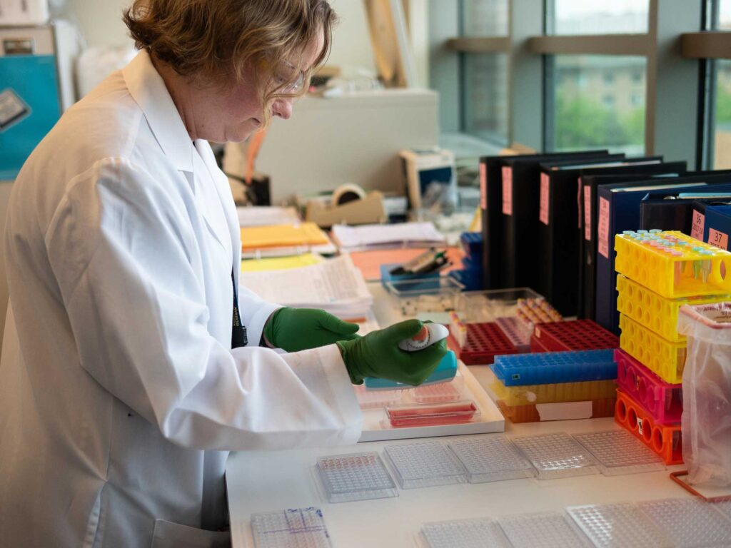 Emily Martin, associate professor of epidemiology at U-M's School of Public Health, working in her lab.
