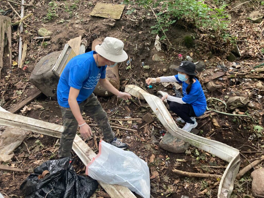 Volunteers clean up Bluffs Nature Area in Ann Arbor during a September 2021 event. Image credit: Zackariah Farah