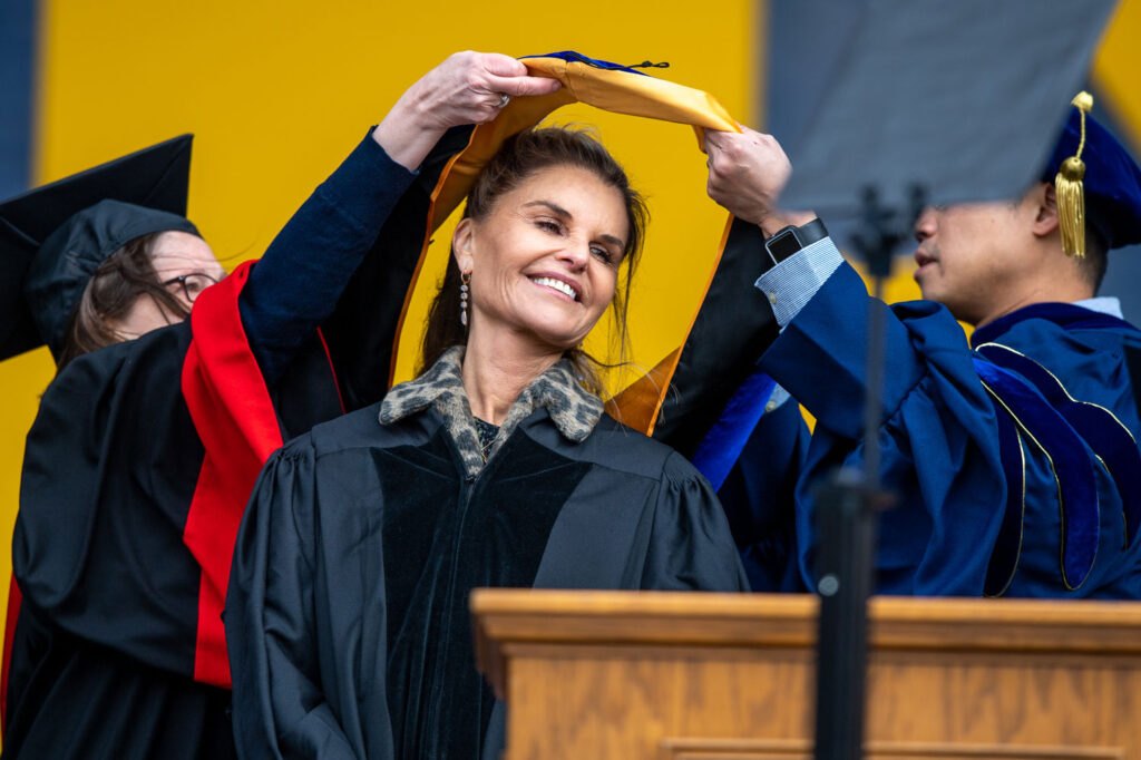 photo of Maria Shriver receiving the hood for her honorary Doctor of Humane Letters degree