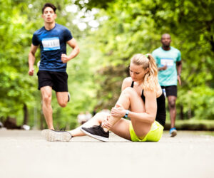 Woman checks injured ankle