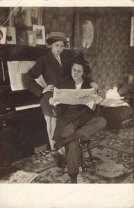 Muskegon: Two ladies in menswear read the newspaper, Tinder Collection