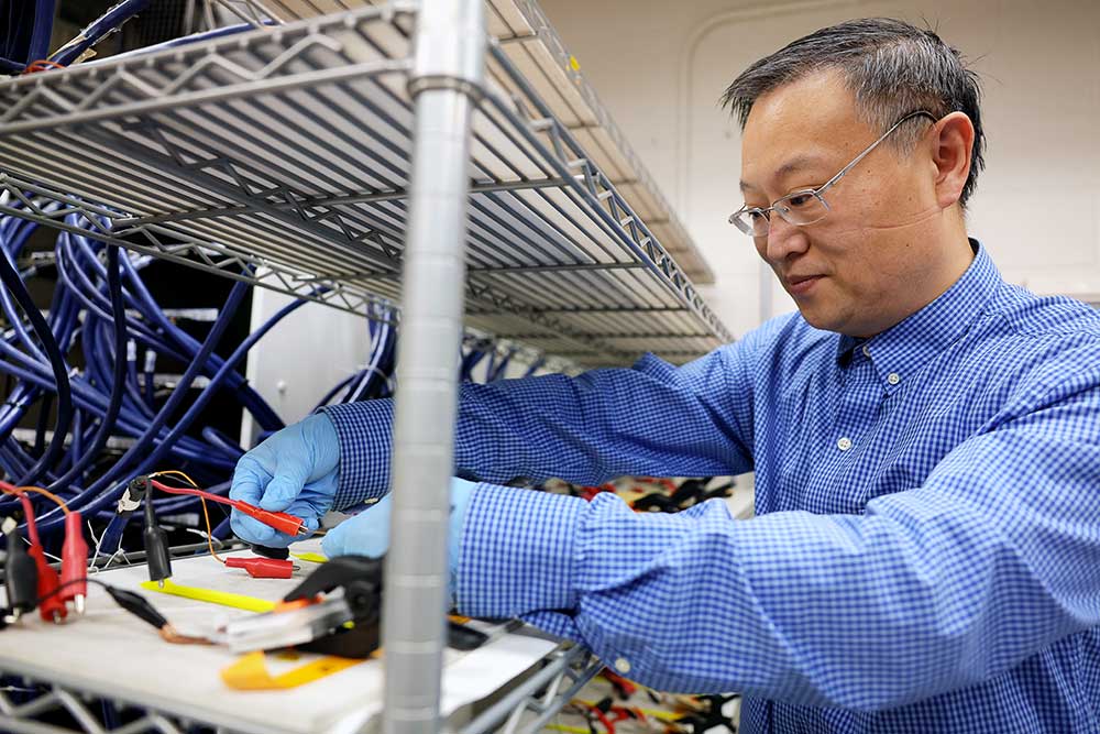 Wei Lu, a U-M professor of mechanical engineering cycling batteries in the Lu Lab at the George G. Brown Laboratories building on the North Campus of the University of Michigan in Ann Arbor. Image credit: Brenda Ahearn, College of Engineering