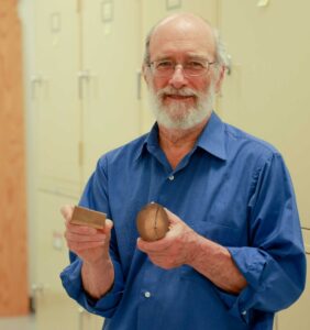 University of Michigan paleontologist Daniel Fisher holding pieces of two well-preserved mastodon tusks (not from the Buesching mastodon). In his right hand is a sample that records the last six years of life of a male mastodon from central lower Michigan. A cross-section of a tusk tip, in Fisher's left hand, shows early years in the life of a mastodon found in southwest Michigan. Image credit: Jeremy Marble, Michigan News