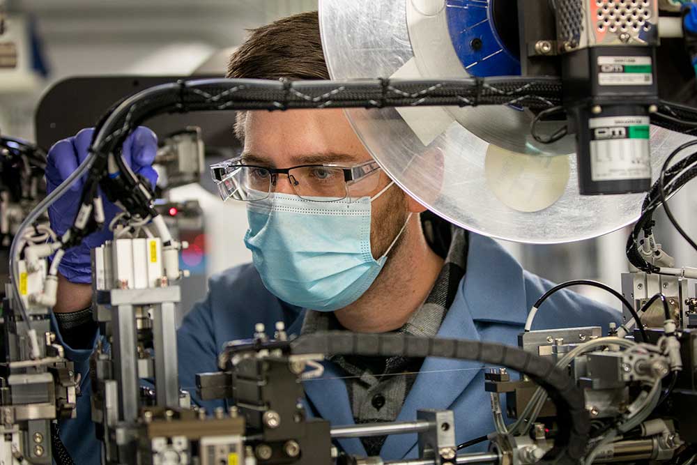 Eric Kazyak, Research Fellow in Mechanical Engineering, tries to verify lithium metal, solid-state batteries which use a solid electrolyte instead of the currently used flammable liquid electrolyte inside the Battery Fabrication and Characterization User Facility at the Phoenix Memorial Laboratory. Photo credit: Robert Coelius/University of Michigan Engineering, Communications & Marketing