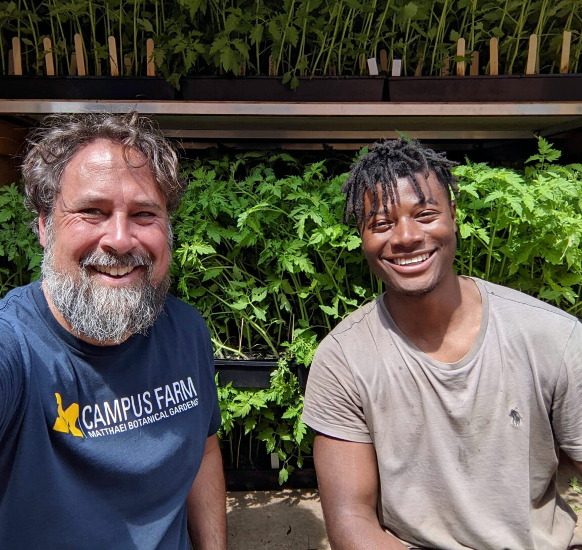 Jeremy Moghtader, left, program manager for the Campus Farm, stands with Akello Karamoko, farm manager for Keep Growing Detroit. The Campus Farm grew 14,000 tomato transplants in collaboration with Keep Growing Detroit this past spring. (Photo by Jeremy Moghtader)
