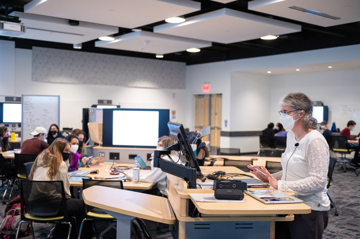 Amy Gottfried, a lecturer IV in LSA, teaches Chemistry 230 in the Central Campus Classroom Building to students who are broken into small groups, each with its own video screen and whiteboard. (Photo by Austin Thomason, Michigan Photography)
