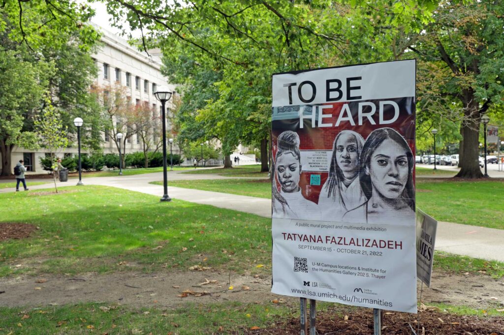 Signage promoting Tatyana Fazlalizadeh's exhibit on the U-M diag. Image credit: Jeremy Marble, Michigan News