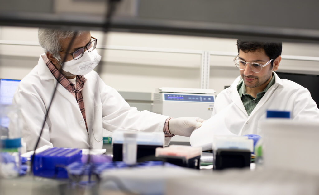 Abhinav Achreja, PhD, Research Fellow at the University of Michigan Biomedical Engineering and Deepak Nagrath, Ph.D. Associate Professor of Biomedical Engineering work on ovarian cancer cell research in the bio-engineering lab at the North Campus Research Center (NCRC). Image credit: Marcin Szczepanski, Michigan Engineering