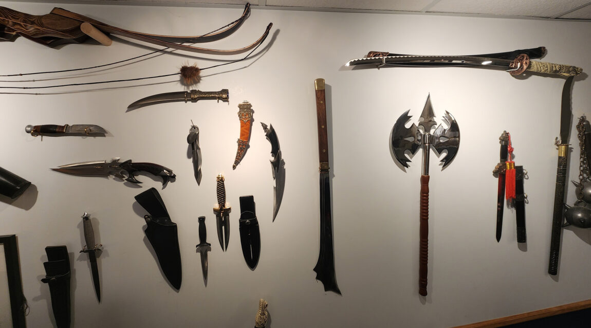 Todd Coon, supervisor for the Procurement Services technology team, has a robust collection of knives and swords on display in the basement of his Ypsilanti home. (Photo courtesy of Todd Coon)