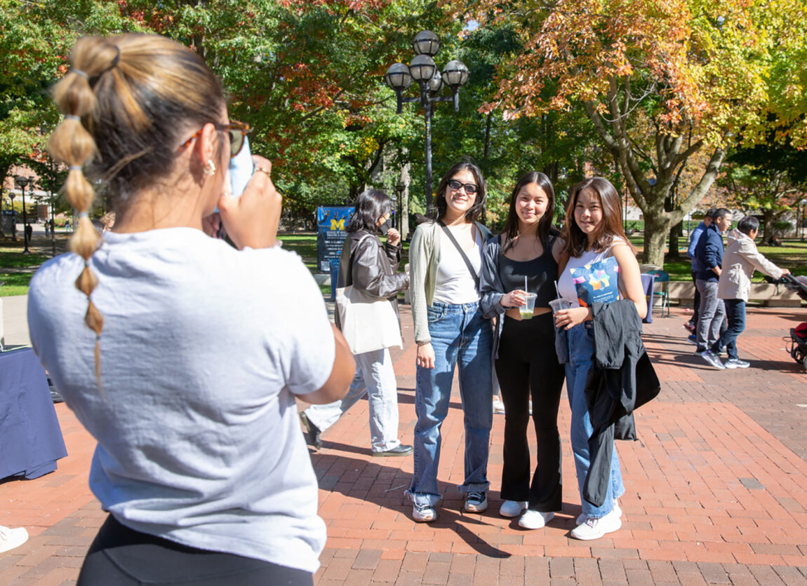 Morgan Brown, left, takes a photo of attendees at Well-being Day on the Diag on Oct. 9. The event was the result of the combined efforts of Student Life and Central Student Government. (Photo by Rebecca Cook)