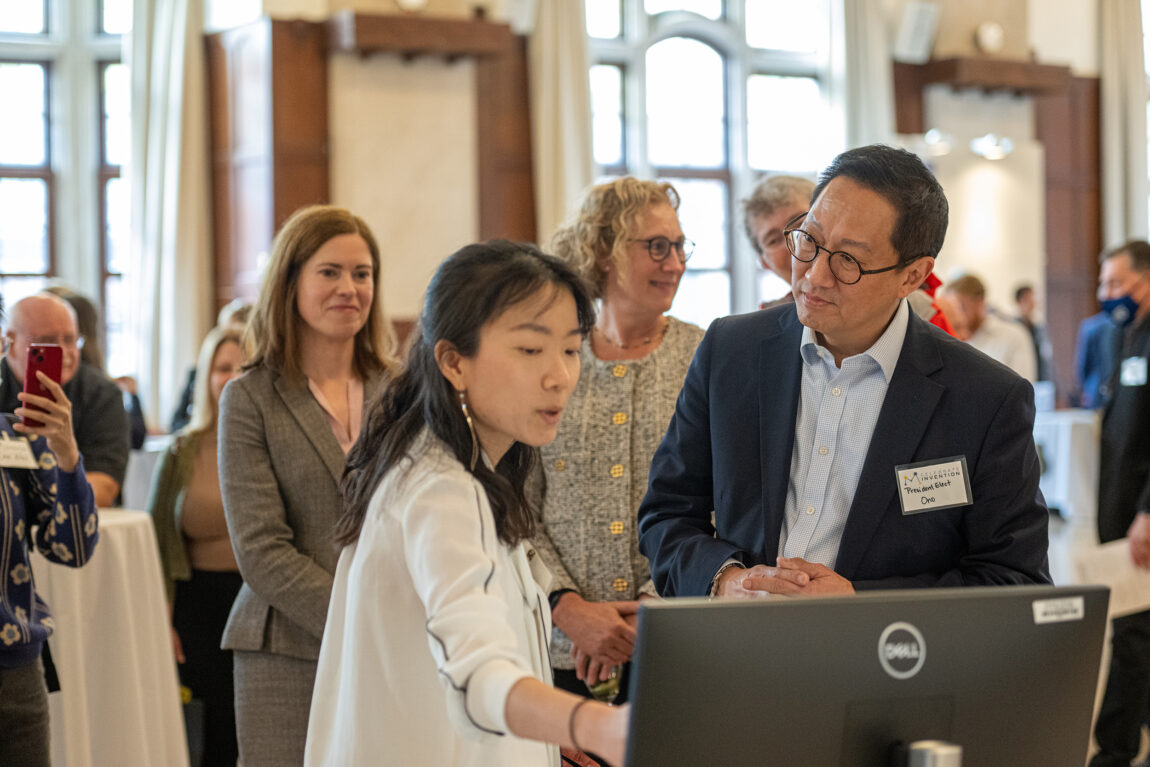 President Santa J. Ono listens as Yan Zhang, assistant professor of biological chemistry, discusses her work on CRISPR-Cas3 during the Celebrate Invention event Oct. 13 at the Michigan Union. Looking on are Kelly Sexton (left), associate vice president for research – innovation partnerships, and Rebecca Cunningham, vice president for research. The annual celebration highlights U-M inventors and the impact of their innovations.