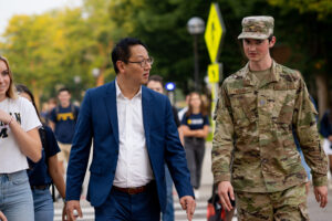 Santa J. Ono walks with an ROTC student