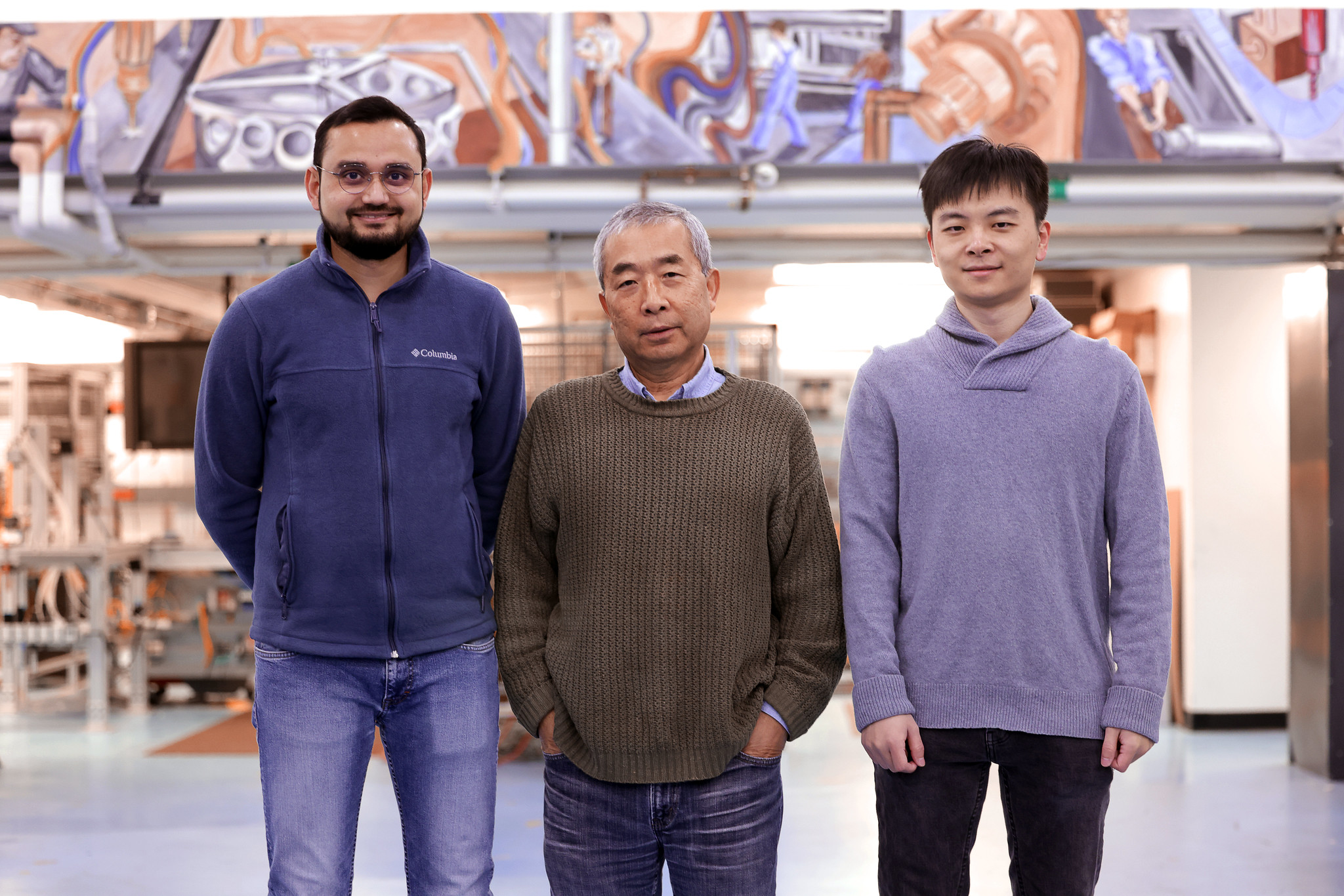 Professor Pingsha Dong (center), the Robert F. Beck Collegiate Professor of Engineering, surrounded by Abdul Khan (left), and Yuning Zhang, both PhD students in naval architecture and marine engineering, at the Herbert H. Dow Building. Their research involves welding plastic to metal in a newly discovered technique where a thin strip of a nylon-6 (PA6) film provides the oxygen needed to force the formation of a nice, connected interface between the metal and plastic. Image credit: Brenda Ahearn, College of Engineering