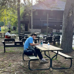 Correa writes at picnic table